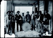 Kalaupapa Band with Brother Serapion van Hoof, SS.CC., on porch of Saint Francis of Assisi Church, Kalaupapa, Molokai, 1903.